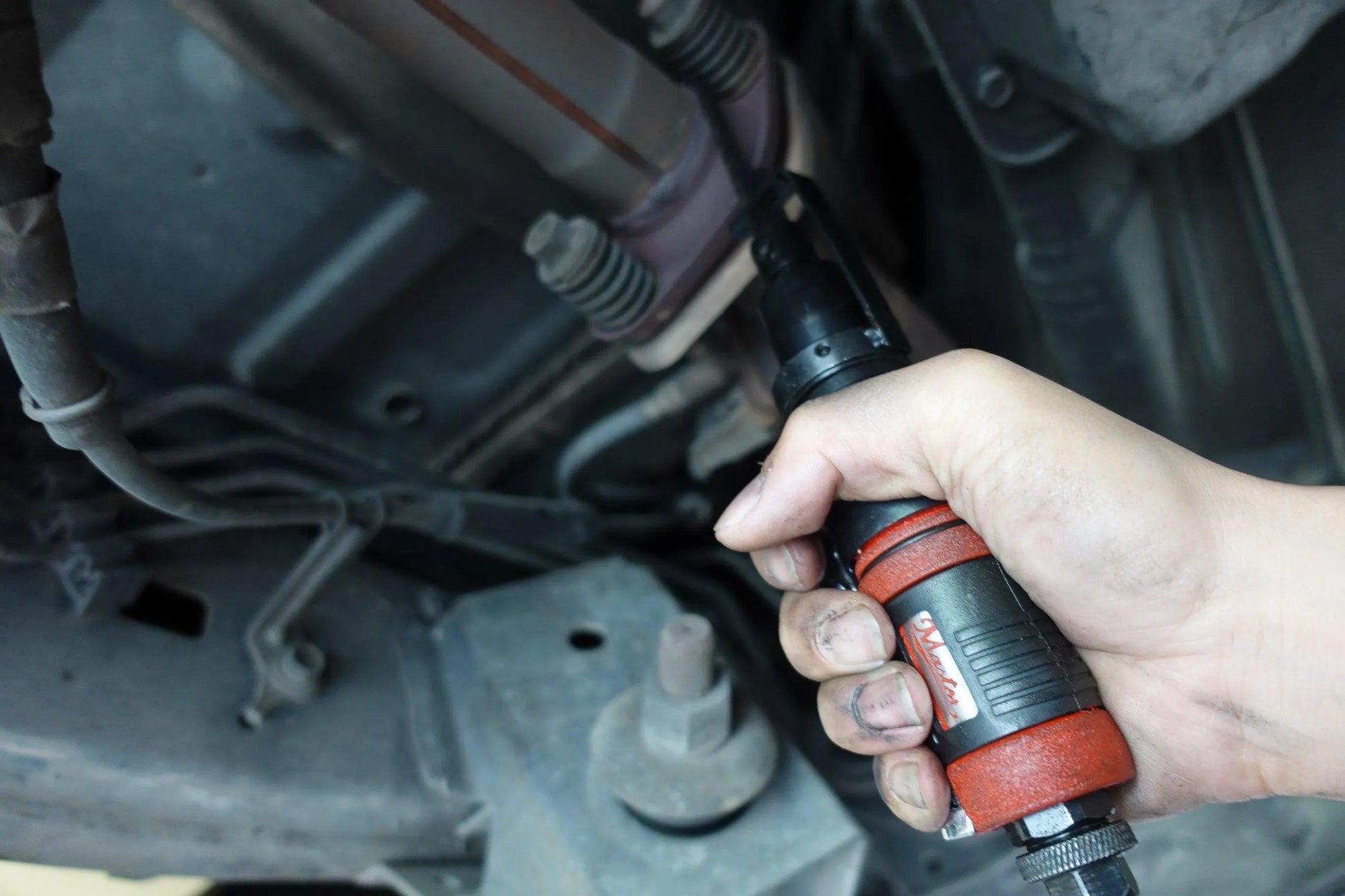 a person is holding a wrench in their hand